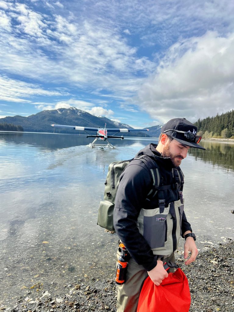 Former USFS Wilderness Ranger and current Wild Coast Excursions Lead Guide Matt Brodsky unloads a floatplane at Pack Creek, Admiralty Island, Alaska.